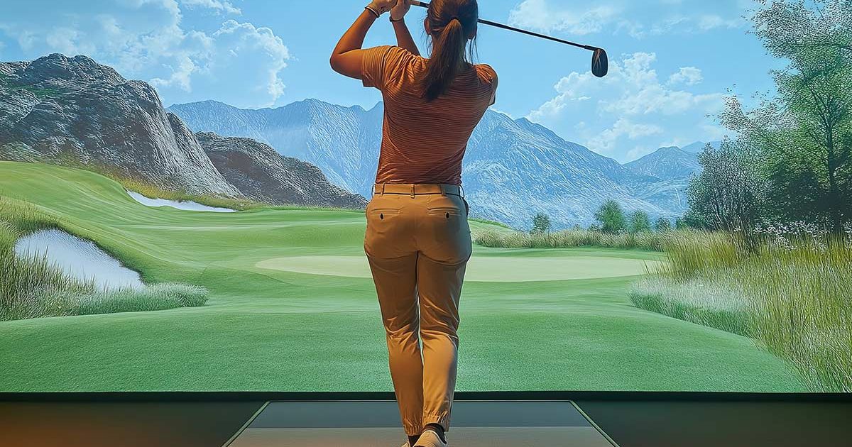 Woman in golf simulator practicing full swing