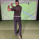 Golfer reviewing golf video analysis on Austin studio monitor