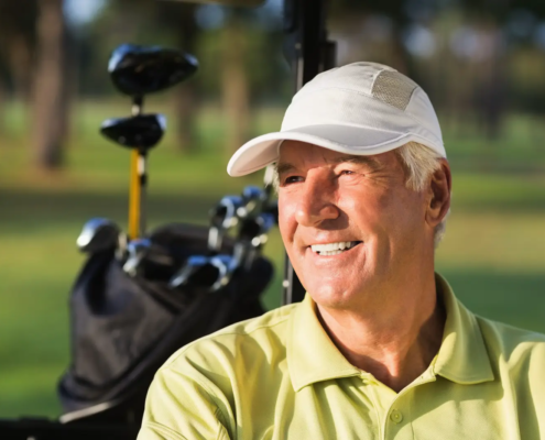 Seasoned player practicing after golf lessons for experienced golfers