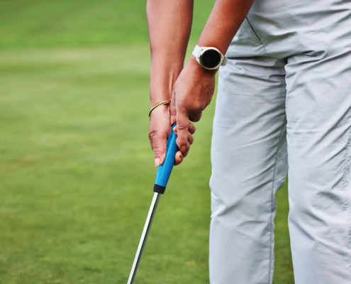 Close-up of golf grip adjustment by a PGA certified instructor