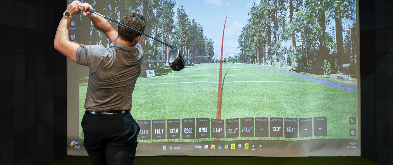 Man practicing drives in a golf simulator