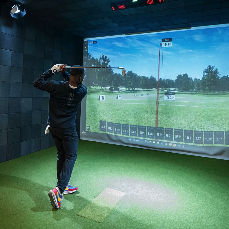 Man swinging in a golf simulator