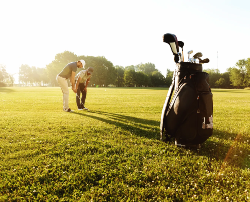 Golf instructor providing one-on-one attention during private golf lessons session